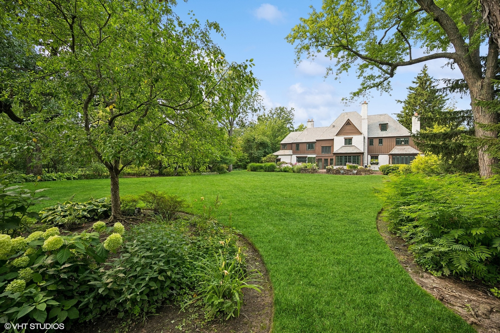 36 Indian Hill Road Winnetka, IL 60093 - Photo 2 of 51 a front view of a house with a yard