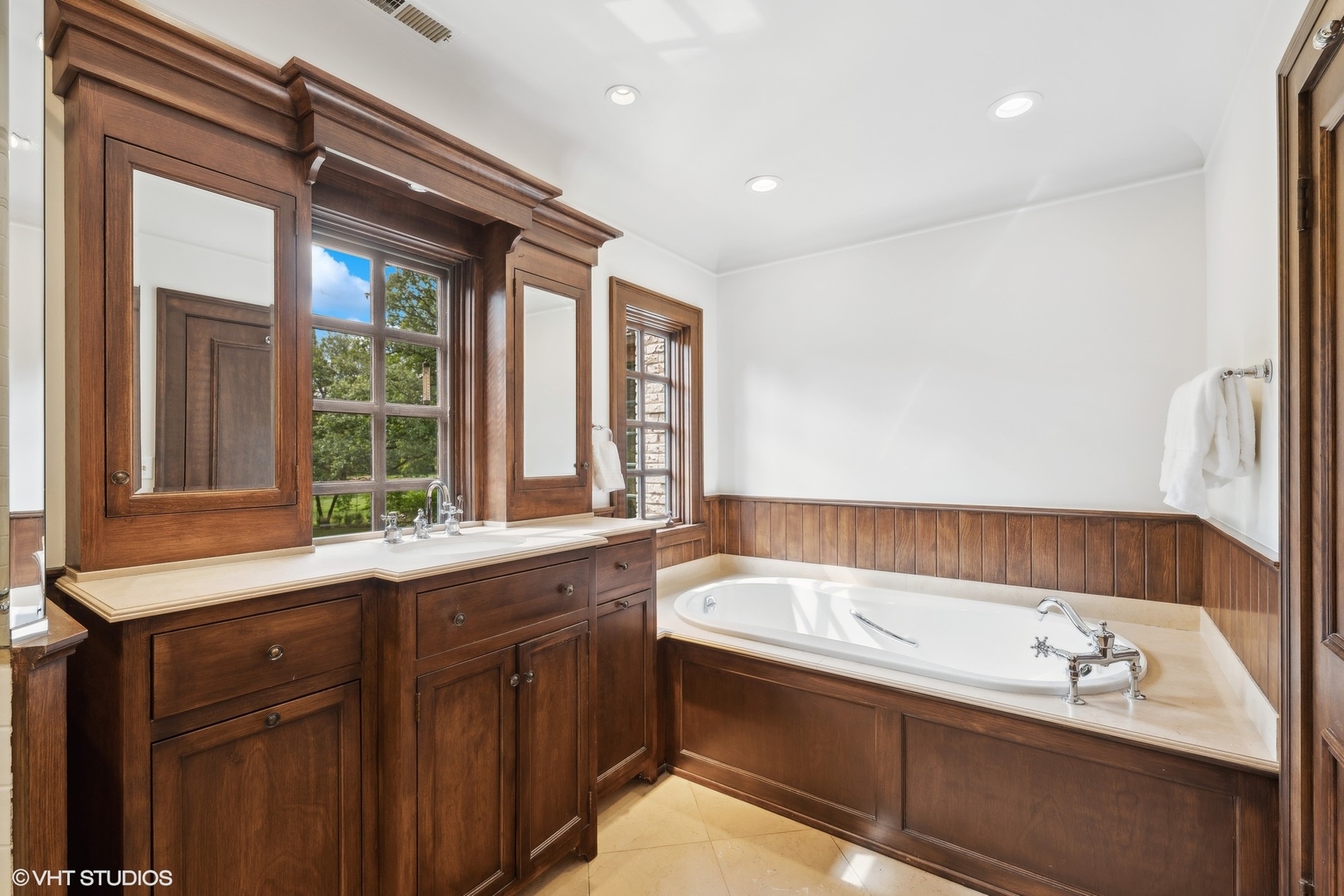 36 Indian Hill Road Winnetka, IL 60093 - Photo 24 of 51 a bathroom with a tub sink and mirror