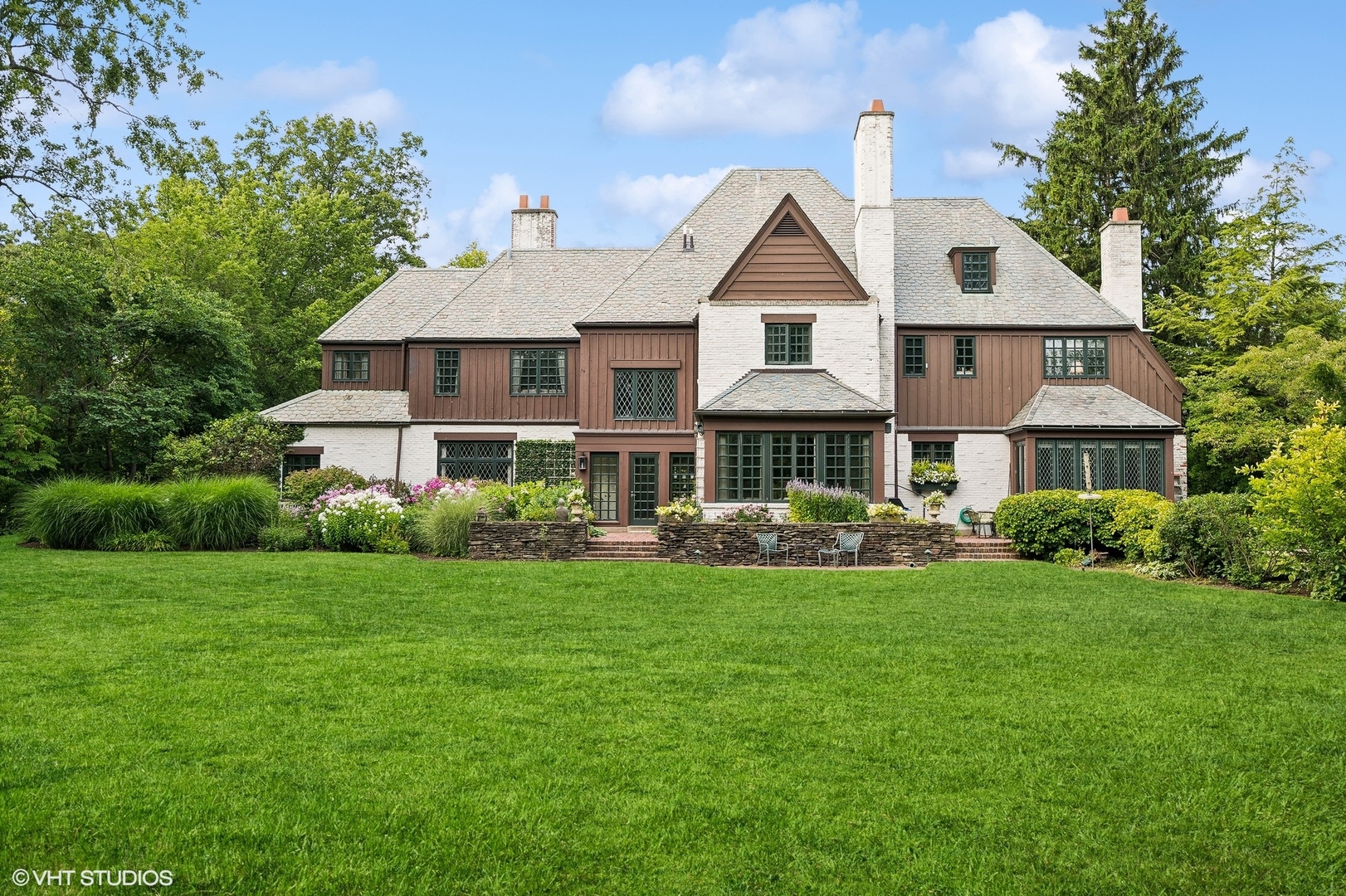 36 Indian Hill Road Winnetka, IL 60093 - Photo 40 of 51 a front view of a house with a garden