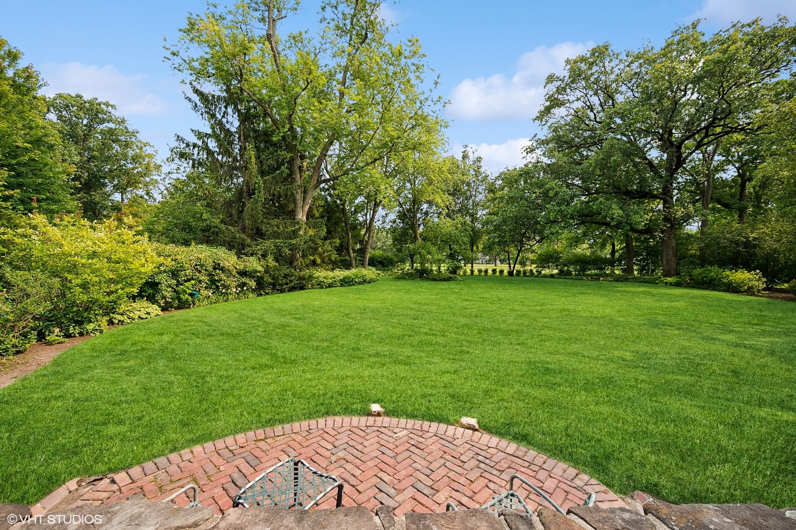 36 Indian Hill Road Winnetka, IL 60093 - Photo 44 of 51 a view of a garden with a bench