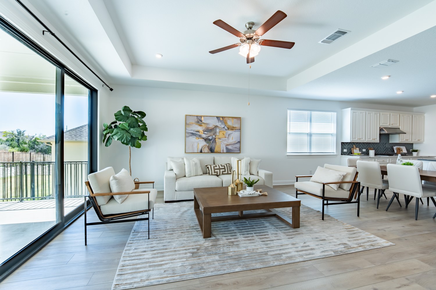 1040 Villa Rialto View Leander, TX 78641 - Photo 2 of 27 Living area featuring ceiling fan, a tray ceiling, light wood finished floors, and recessed lighting