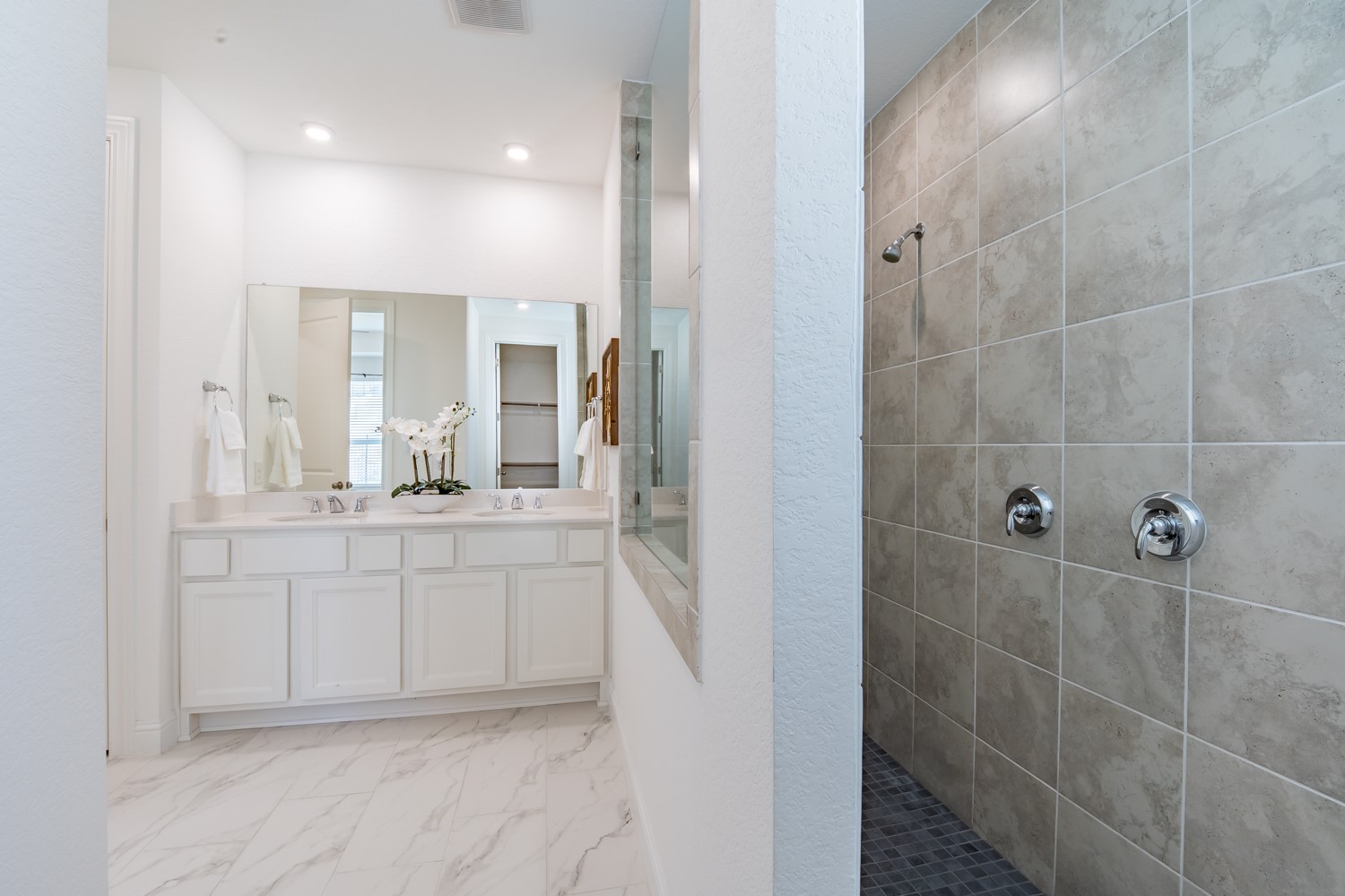 1040 Villa Rialto View Leander, TX 78641 - Photo 21 of 27 Full bath with walk in shower, double vanity, and light marble finish flooring