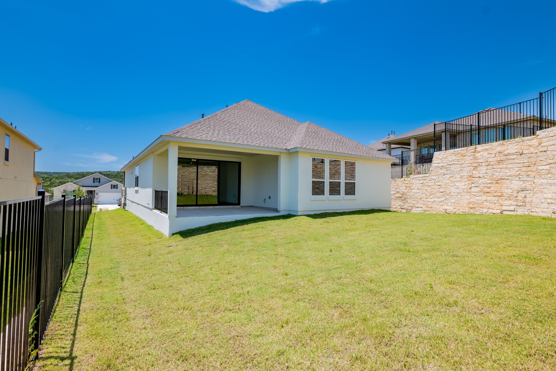 1040 Villa Rialto View Leander, TX 78641 - Photo 25 of 27 Rear view of house with a shingled roof, stucco siding, and a patio area