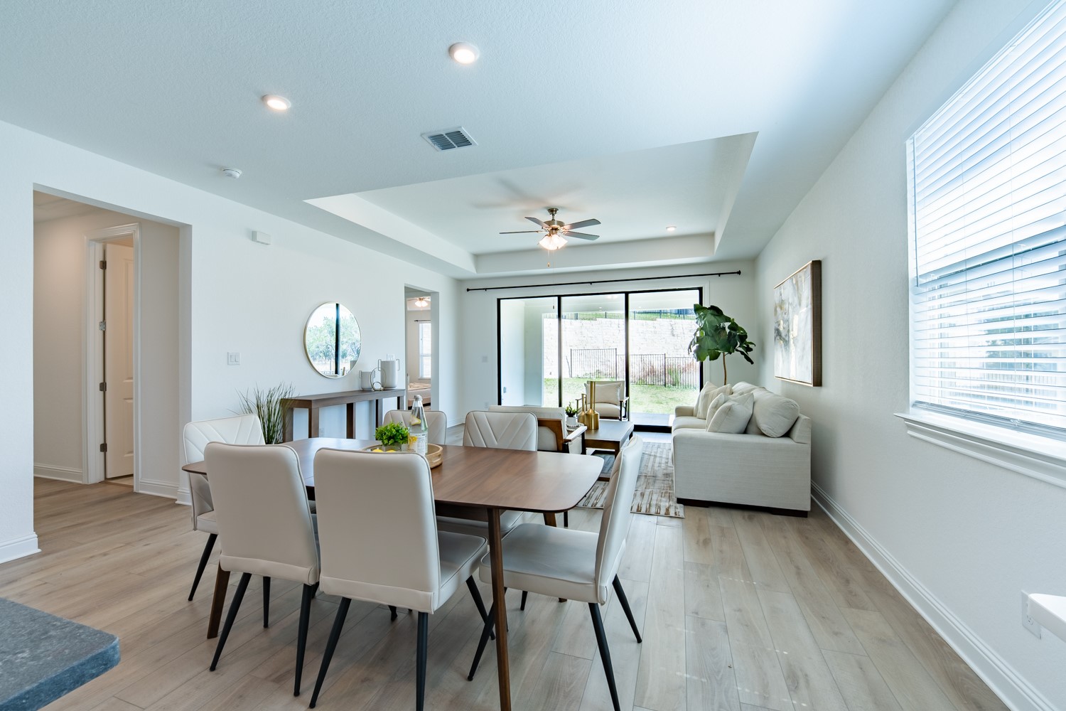 1040 Villa Rialto View Leander, TX 78641 - Photo 4 of 27 Dining room with a tray ceiling, ceiling fan, light wood-style flooring, and recessed lighting