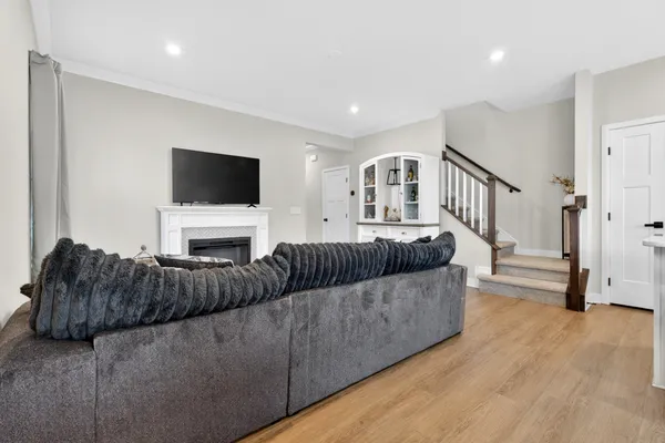 a living room with furniture and kitchen view