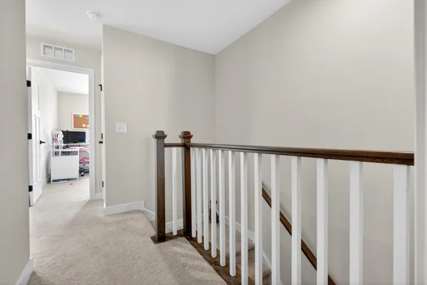 a bedroom with a bed and a chair