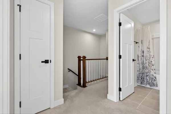 a bedroom with a bed and a flat tv screen on the dresser
