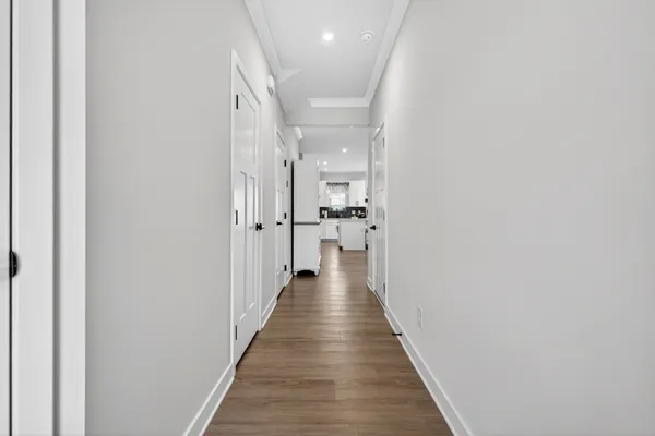 a view of a hallway with wooden floor
