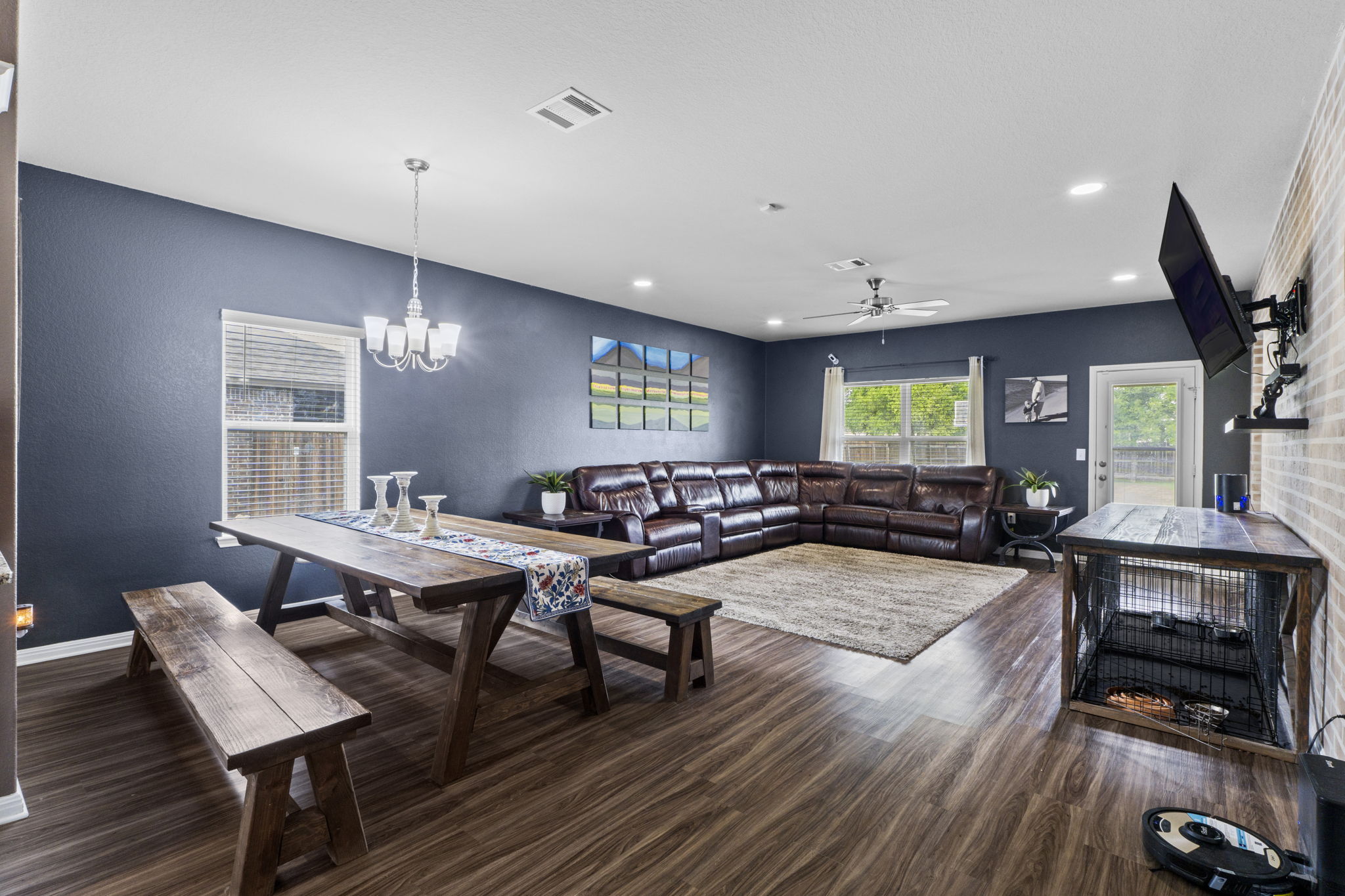 2417 Bridges Ranch Road Georgetown, TX 78628 - Photo 5 of 36 Dining room with ceiling fan, dark wood-style flooring, hanging lights, and a textured wall
