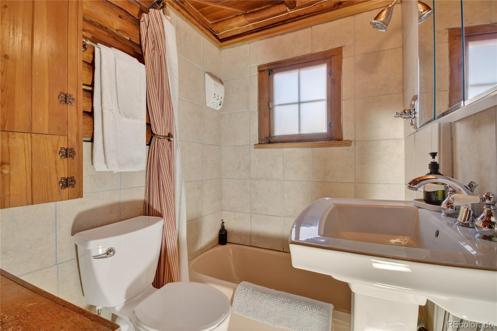 23301 Shoshone Road Indian Hills, CO 80454 - Photo 19 of 32 a bathroom with a sink and a bathtub