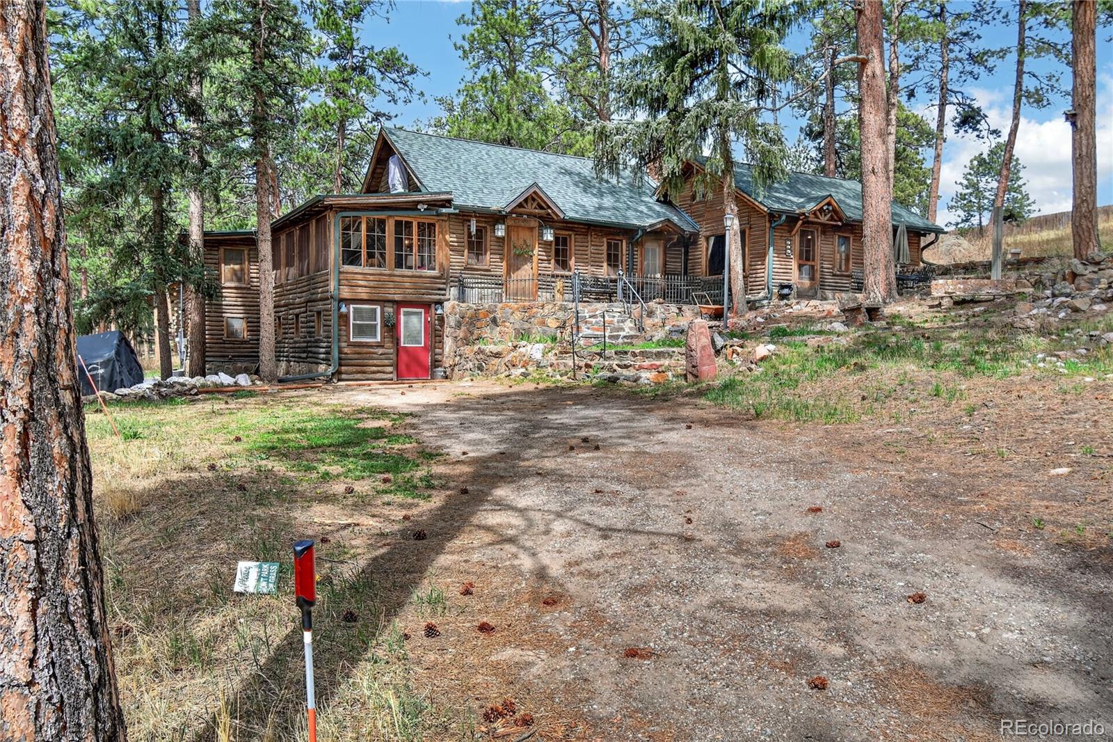 23301 Shoshone Road Indian Hills, CO 80454 - Photo 20 of 32 front view of a house with a yard