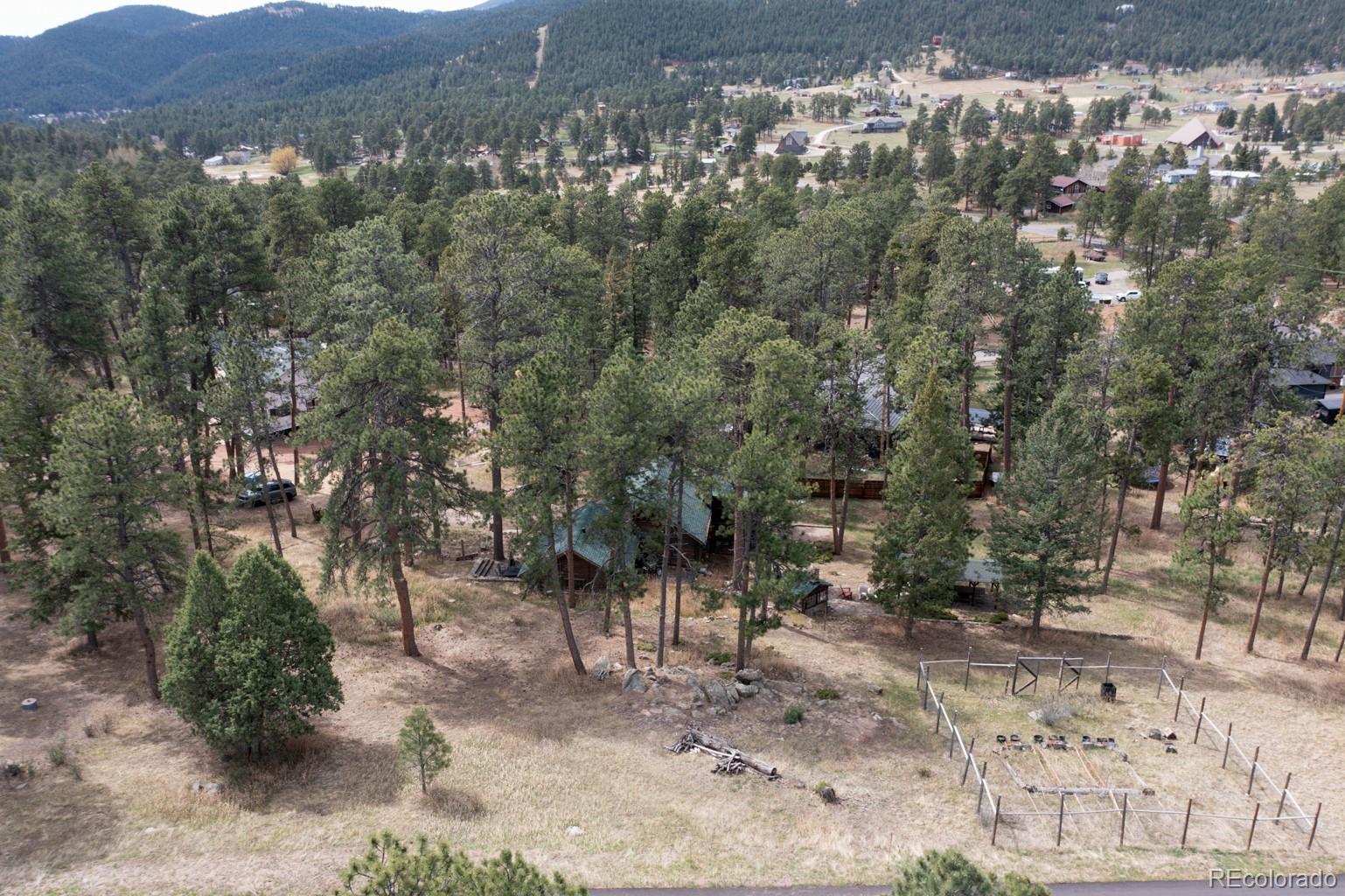 23301 Shoshone Road Indian Hills, CO 80454 - Photo 22 of 32 a view of a large yard with lots of green space and fog