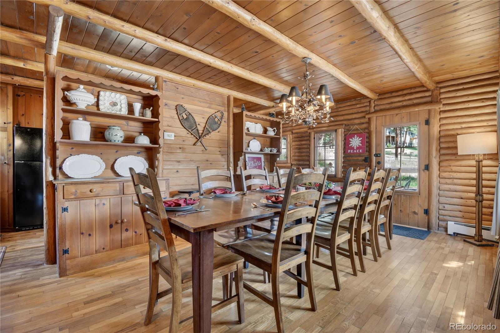 23301 Shoshone Road Indian Hills, CO 80454 - Photo 9 of 32 a view of a dining room with furniture and chandelier