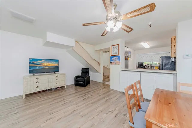 a view of a kitchen with furniture and wooden floor