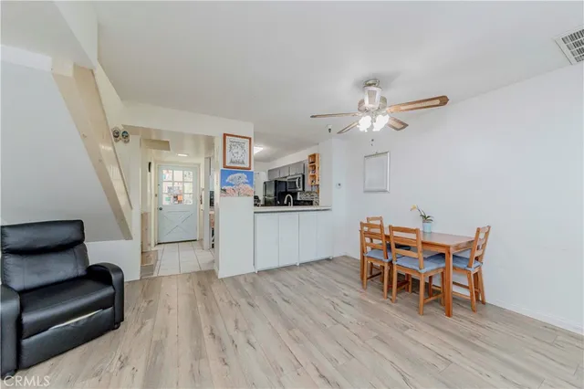 a dining room with furniture and wooden floor
