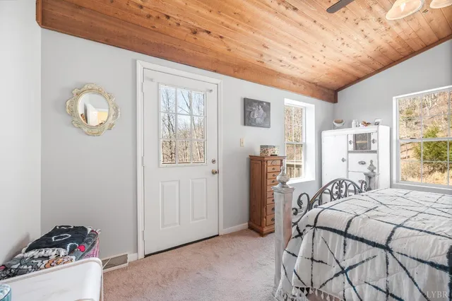 a view of house with deck and wooden floor