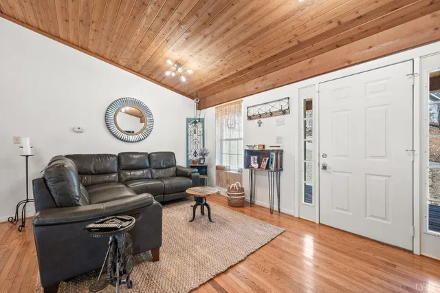 a view of a livingroom with furniture and a book shelf