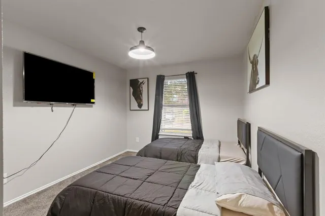 a bedroom with a bed and a flat screen tv