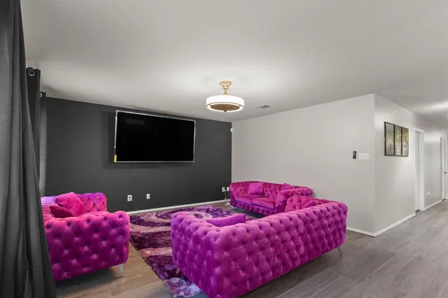 a bedroom with furniture and a flat screen tv