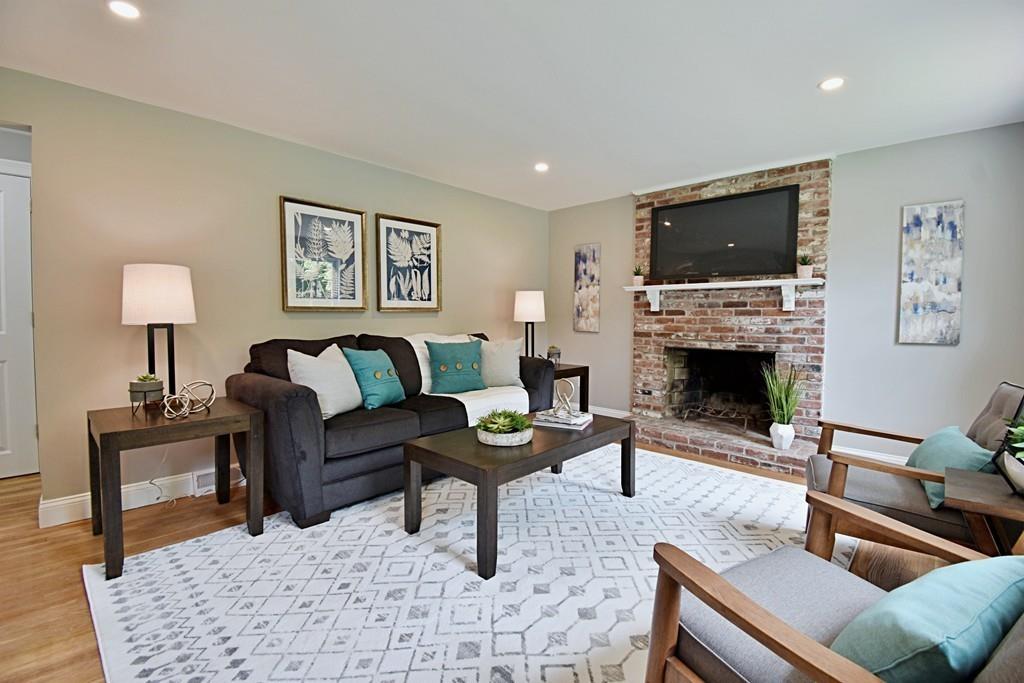 65 Spaulding Road Chelmsford, MA 01824 - Photo 16 of 42 a living room with furniture a flat screen tv and a fireplace
