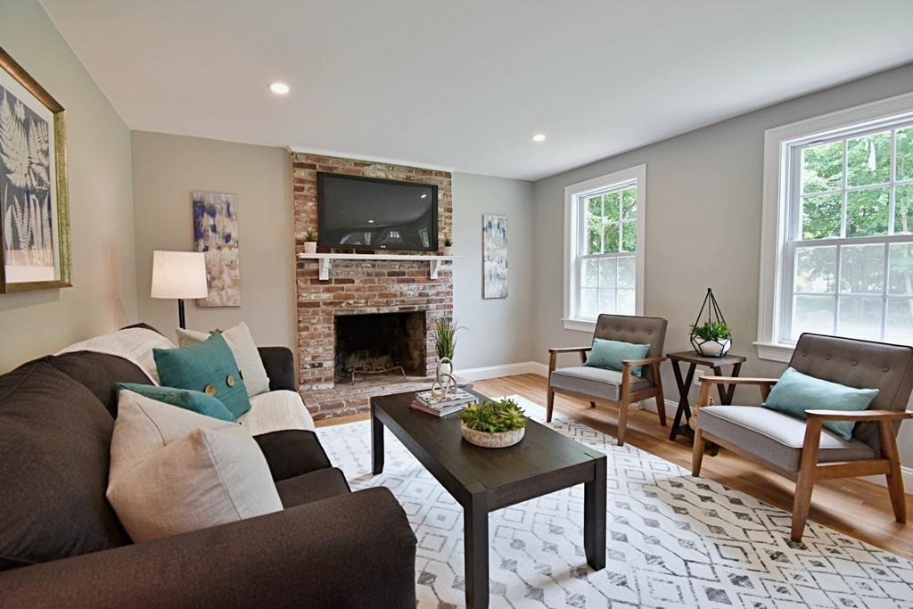 65 Spaulding Road Chelmsford, MA 01824 - Photo 17 of 42 a living room with furniture a flat screen tv and a fireplace