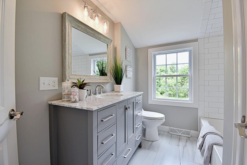65 Spaulding Road Chelmsford, MA 01824 - Photo 29 of 42 a bathroom with a granite countertop sink mirror and a toilet