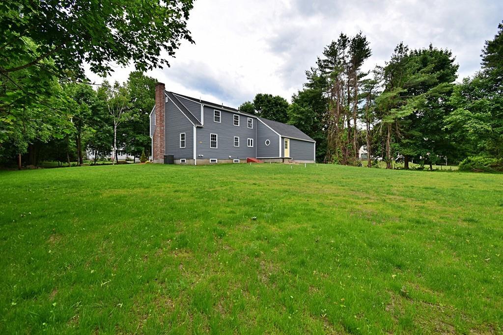 65 Spaulding Road Chelmsford, MA 01824 - Photo 3 of 42 a house view with garden space and trees
