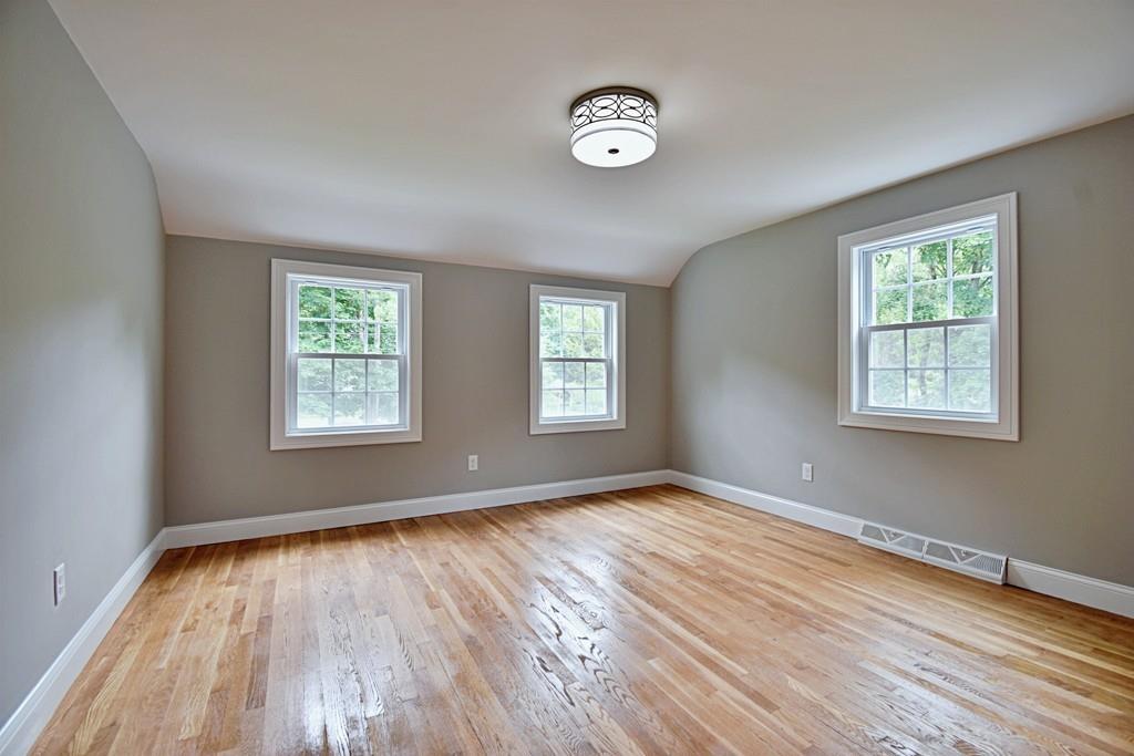 65 Spaulding Road Chelmsford, MA 01824 - Photo 34 of 42 a view of an empty room with wooden floor and a window