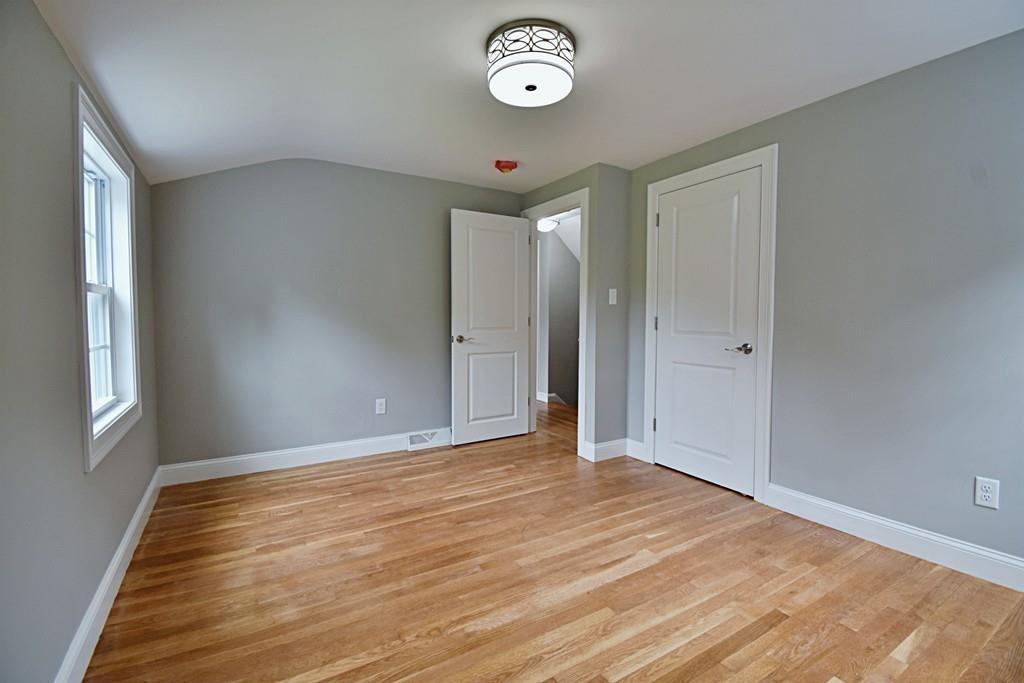 65 Spaulding Road Chelmsford, MA 01824 - Photo 36 of 42 a view of an empty room with wooden floor and a window