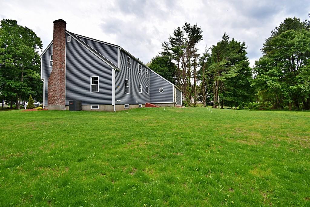 65 Spaulding Road Chelmsford, MA 01824 - Photo 4 of 42 a view of a house with a yard