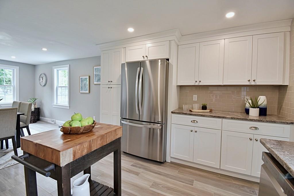 65 Spaulding Road Chelmsford, MA 01824 - Photo 10 of 42 a kitchen with granite countertop a white cabinets and stainless steel appliances