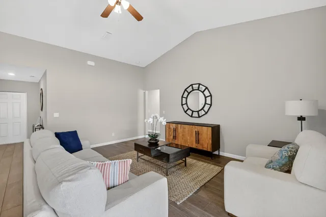 a living room with furniture and a fireplace