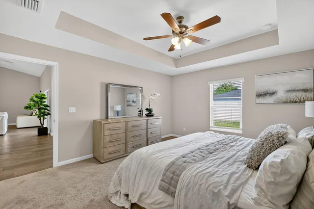 a bedroom with a bed and a chandelier