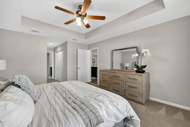 a bedroom with a large bed and a chandelier