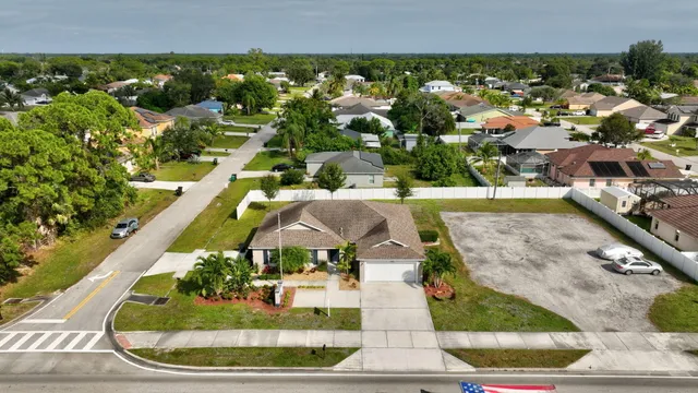 an aerial view of a house with a yard and lake view