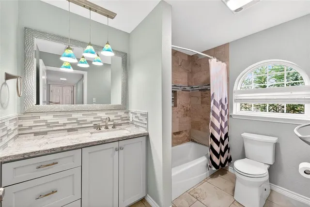 a bathroom with a sink a toilet and a shower curtain