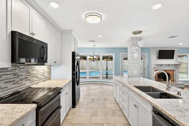 a large kitchen with a stove and a large window