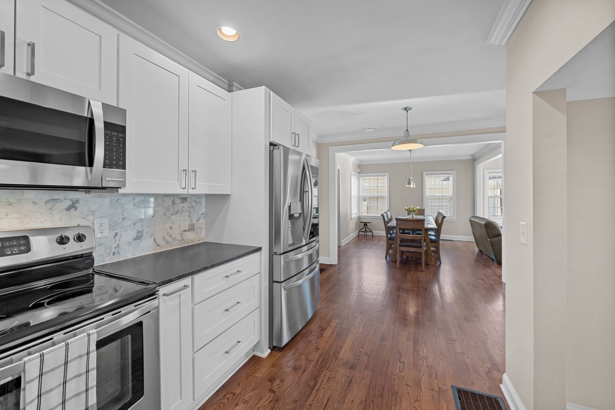 816 Inverness Avenue Nashville, TN 37204 - Photo 13 of 39 a kitchen with white cabinets and stainless steel appliances