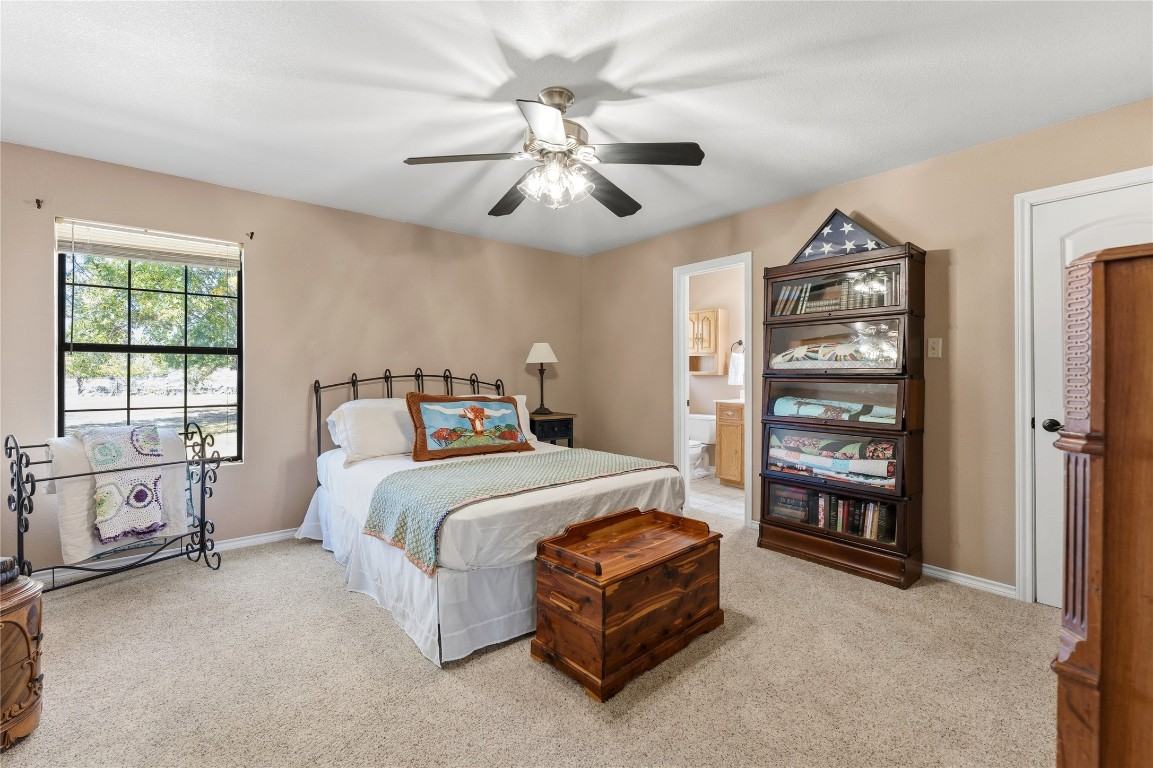 306 Starview Drive Georgetown, TX 78628 - Photo 15 of 26 Bedroom #2 featuring light colored carpet, ceiling fan, and ensuite full bathroom