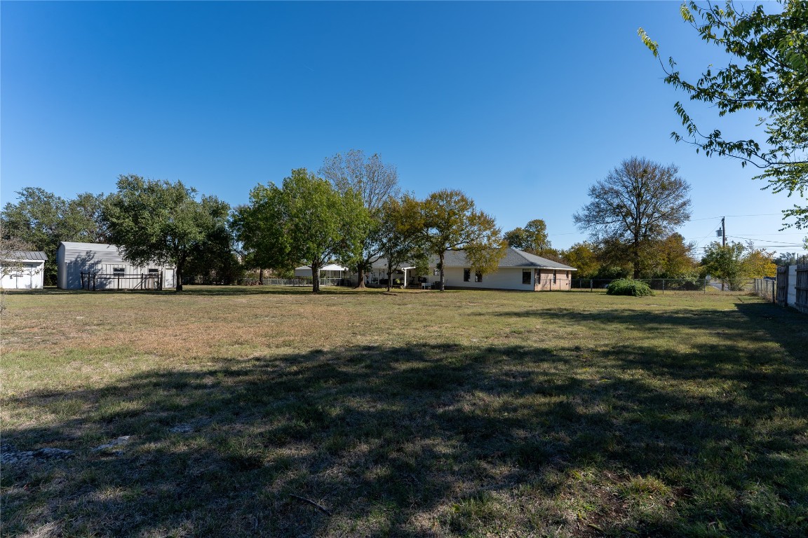 306 Starview Drive Georgetown, TX 78628 - Photo 5 of 26 View of large backyard, workshop, and storage shed