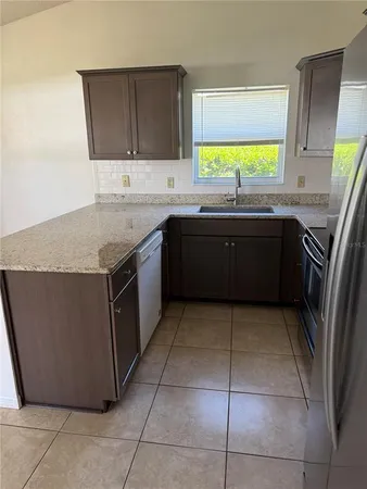 a kitchen with a sink a stove and a microwave