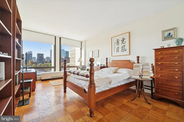 a bedroom with a bed and a view of balcony