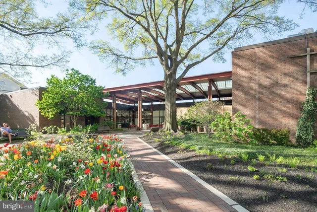 a backyard of a house with lots of green space and fountain