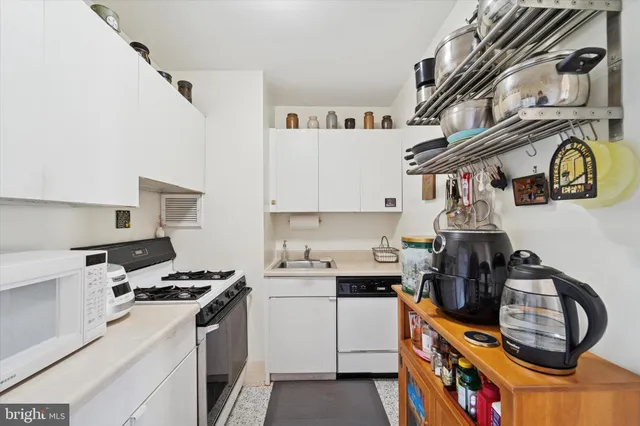 a kitchen with stainless steel appliances granite countertop a stove and a sink
