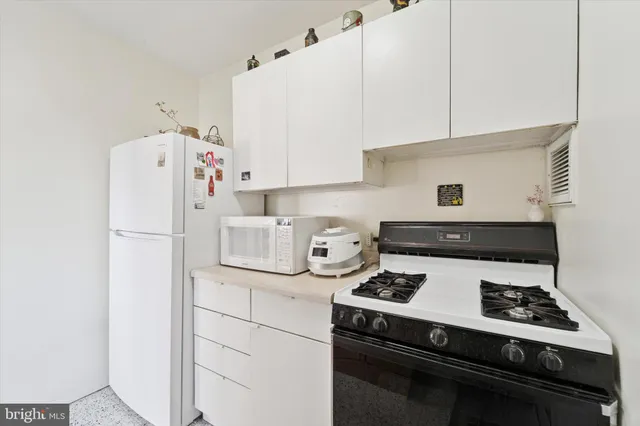 a white refrigerator freezer sitting inside of a kitchen