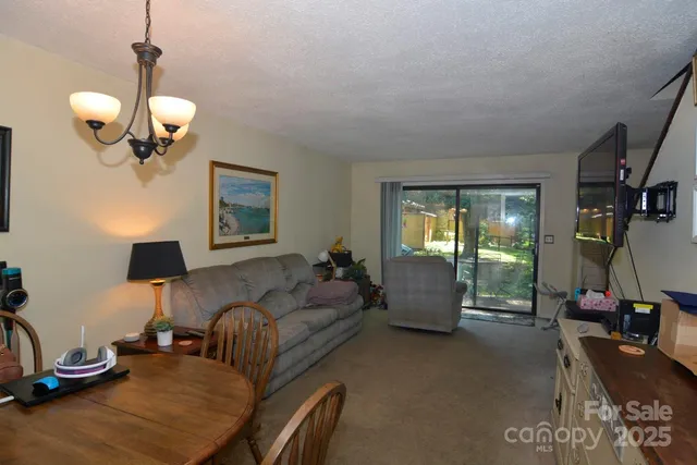 a living room with furniture chandelier and window