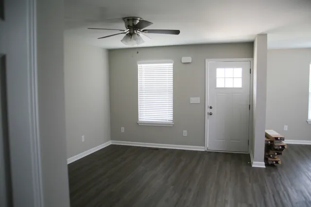 a view of a room with wooden floor
