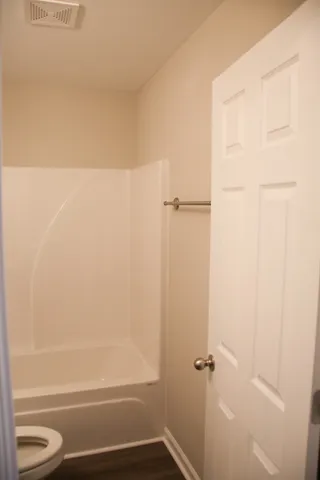 a bathroom with a sink vanity and toilet