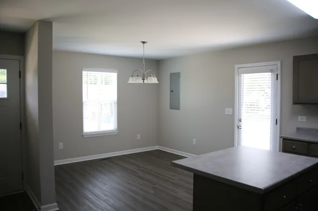 a kitchen with a sink cabinets and wooden floor