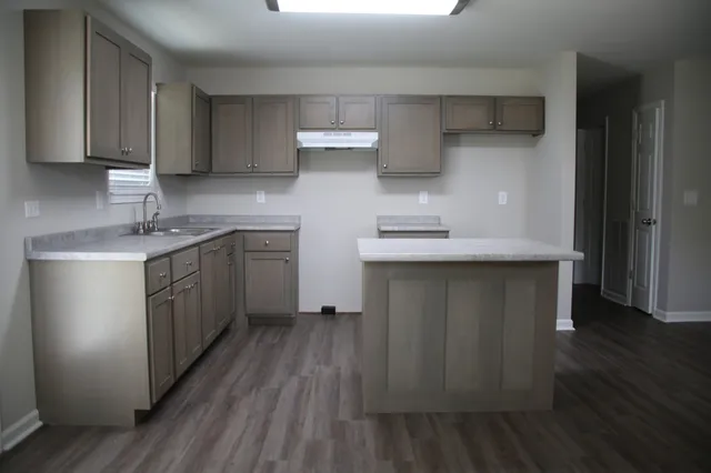 a kitchen with a sink and cabinets
